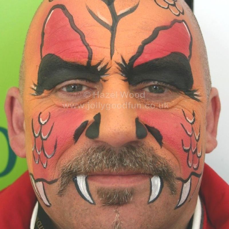 adult with face painted as Fire Dragon
