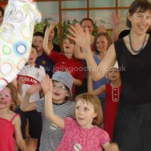 Children and adults doing a party dance