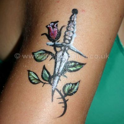 Temporary tattoo daggar on arm