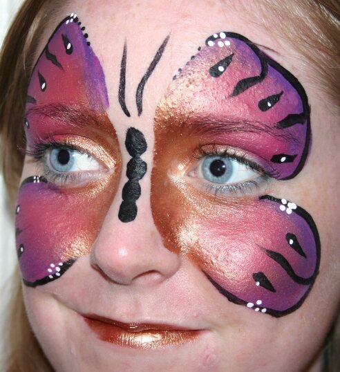 Pink and purple butterfly face-painting design by Hazel Wood