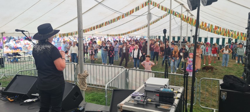 Hazel on stage at a line dancing event