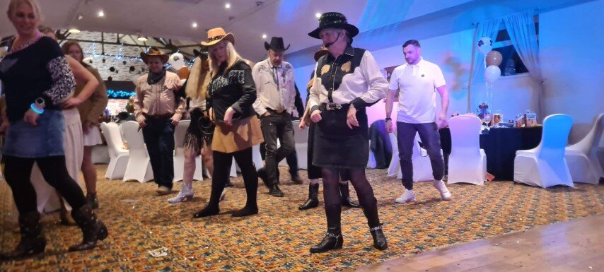 Line dancers following Hazel's instructions