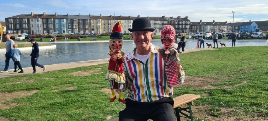 Audience watching a Punch and Judy show