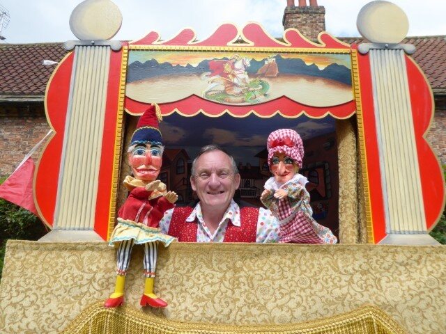 Colourful Punch and Judy booth at an event