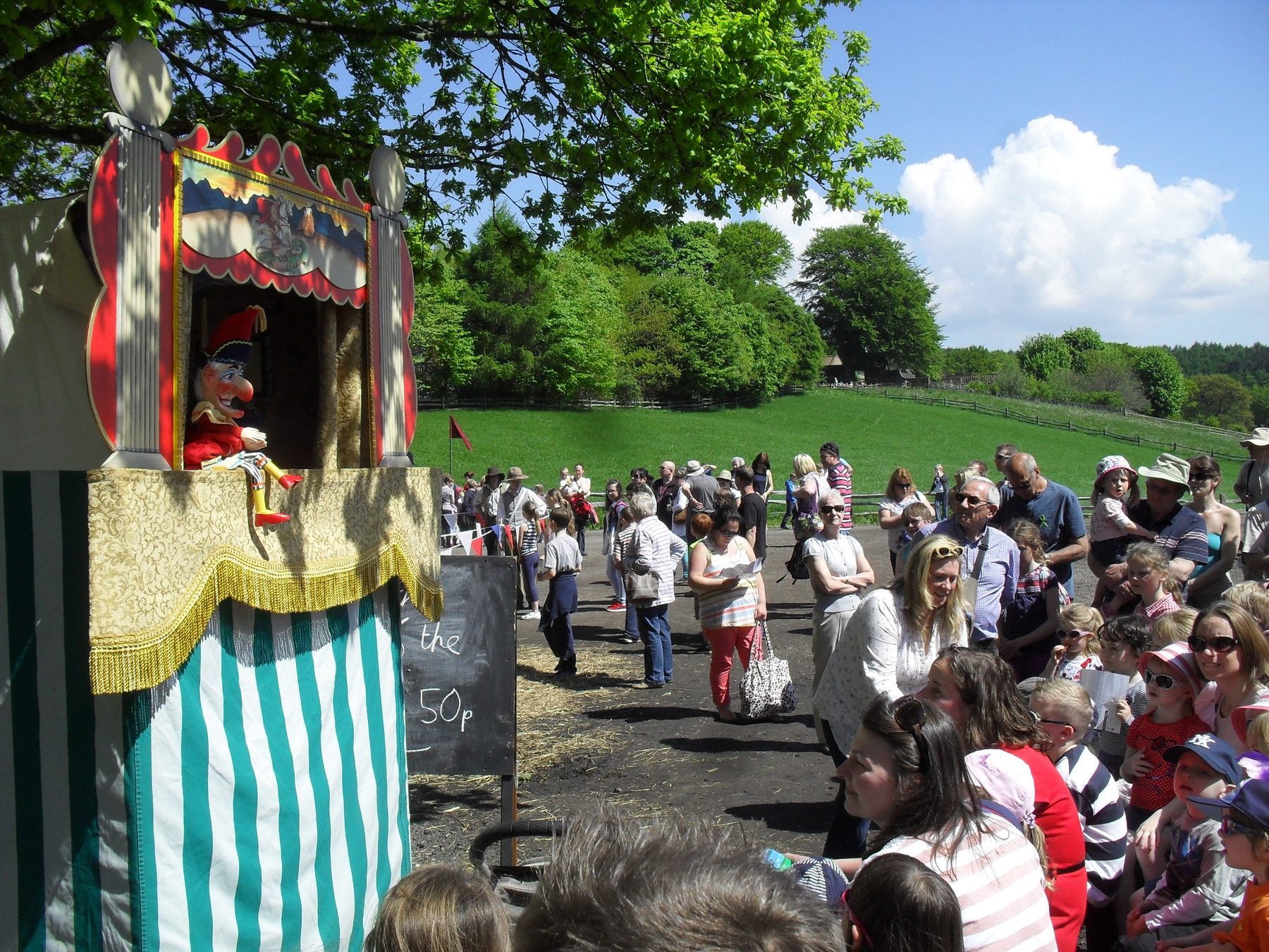 Professor Ron performing Punch and Judy for a large outdoor audience at Beamish Museum's Georgian Fair