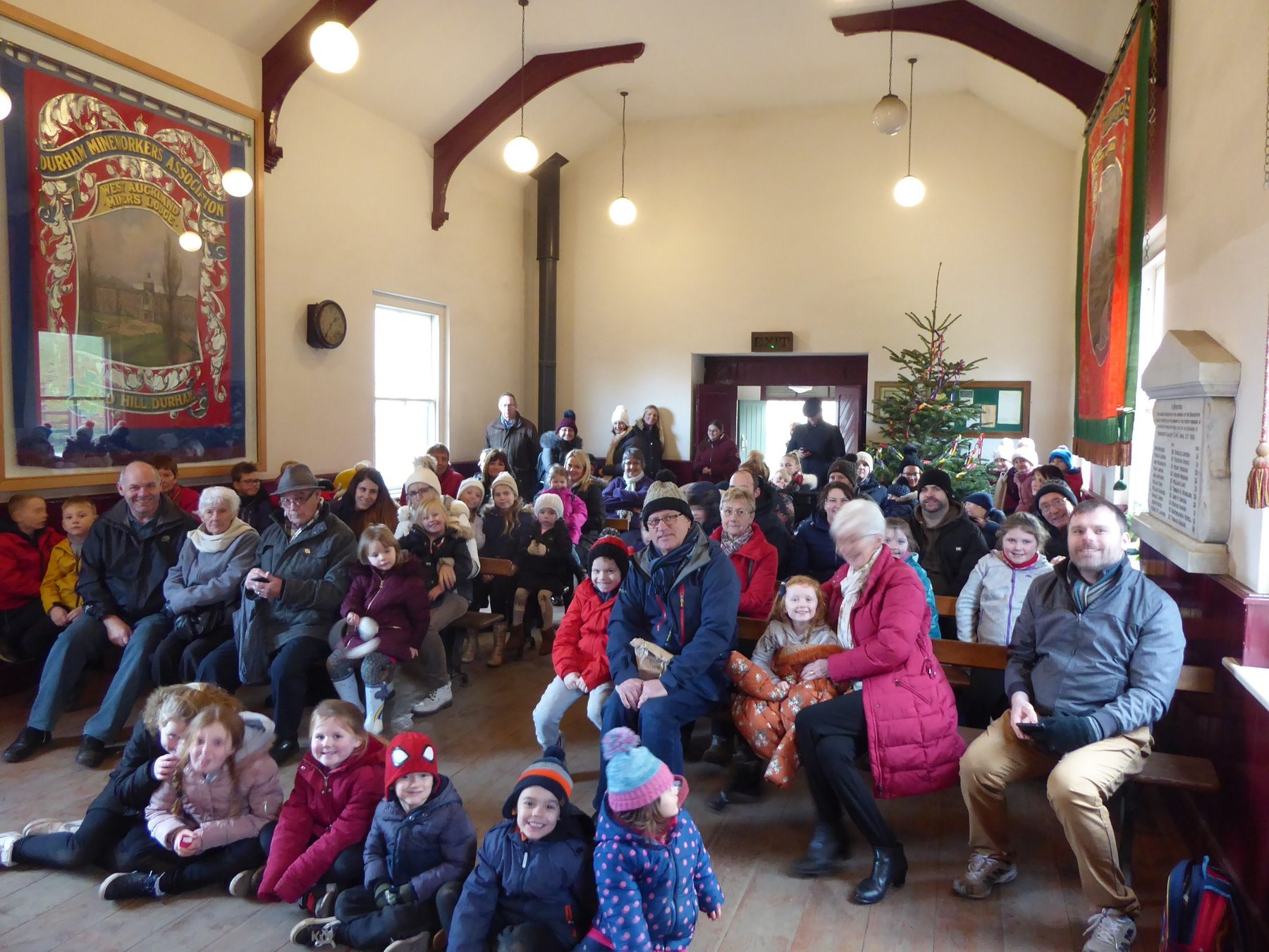 Audience waiting for a Punch and Judy show in the Band Hall at Beamish during the Twelve Days of Christmas event