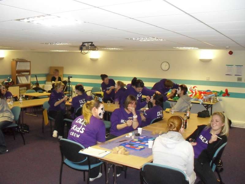 Participants working together during the face painting training course