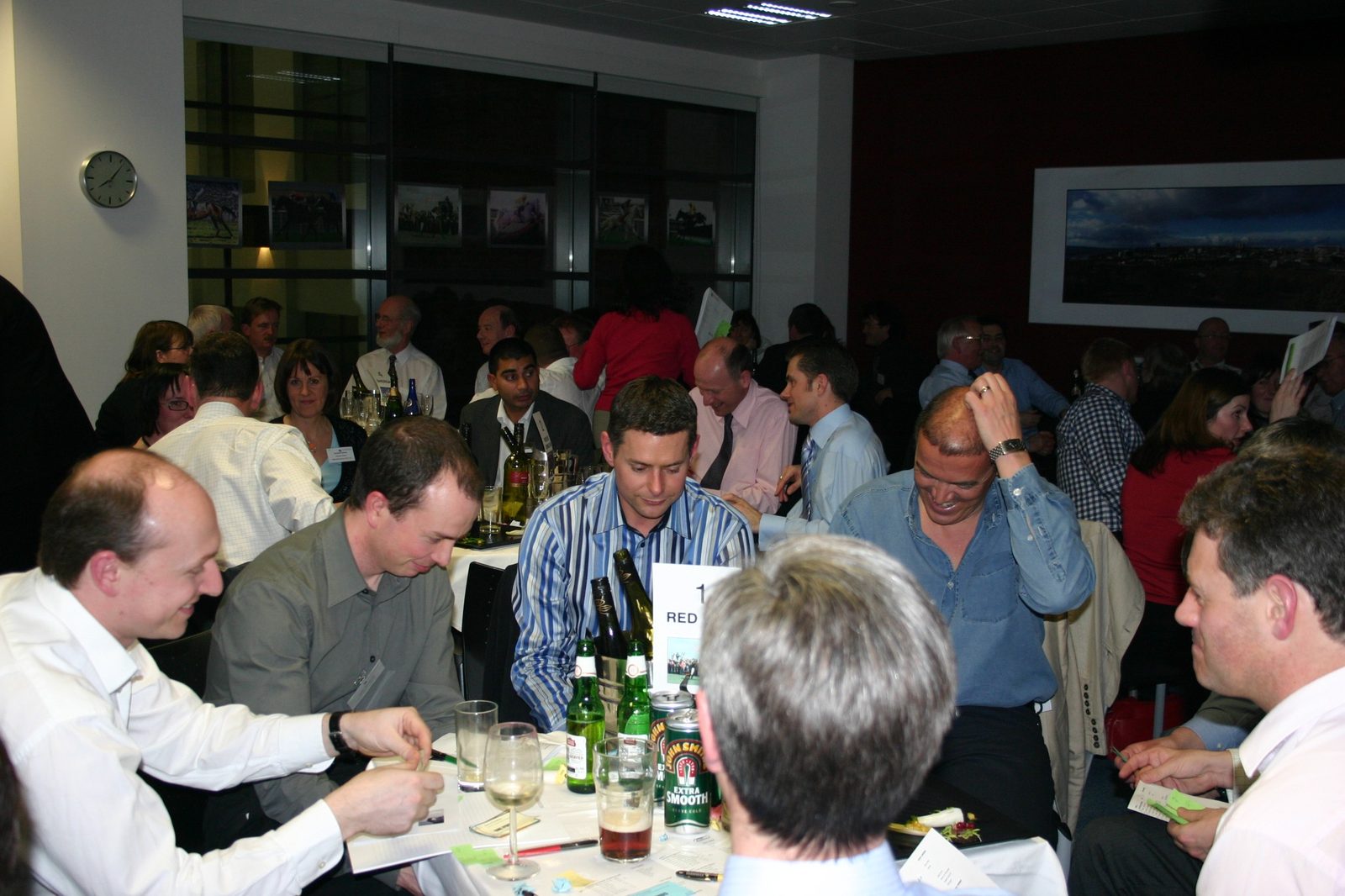 Guests seated at a table with a customised race card during the Eversheds Race Night