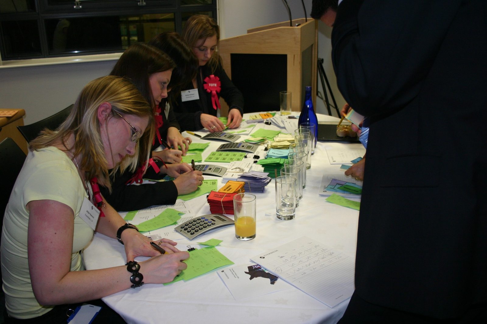 Eversheds staff preparing betting slips, calculators and toy money at the Tote