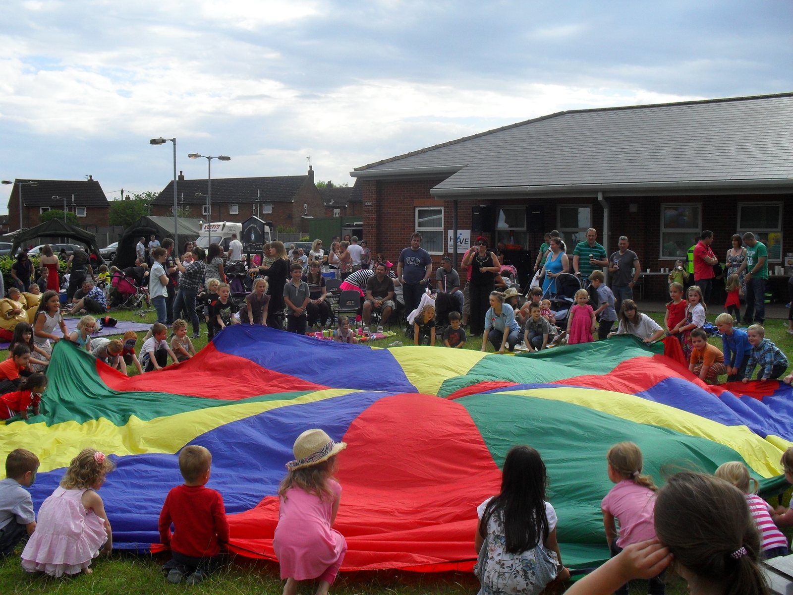 Children and families enjoying parachute games at an RAF family event