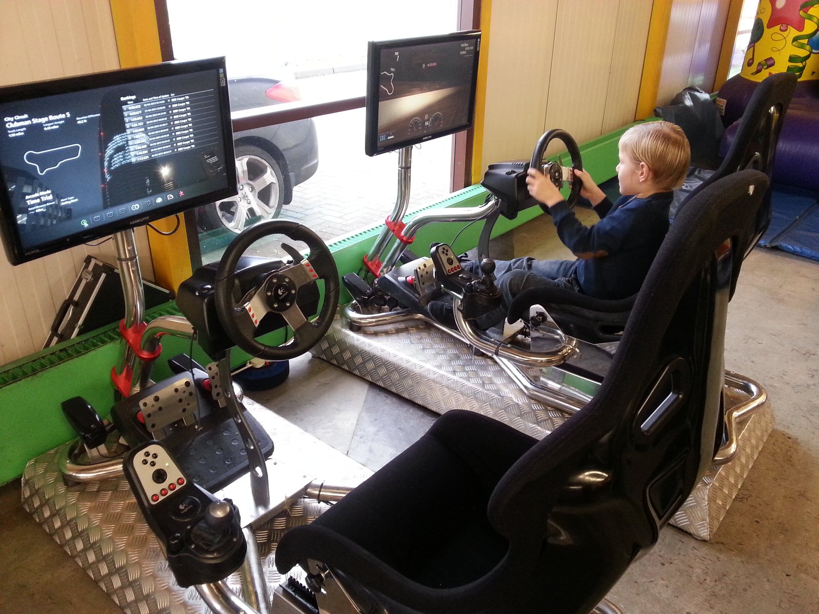 Children using electronic racing attractions at the NSK Christmas party